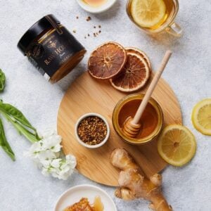 Raw Honey with Propolis, Bee Pollen and Royal Jelly flatly on a table - beehive superfood