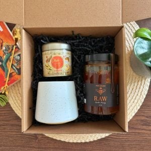 Unwind Gift Box featuring 500g raw honey, Olinda turmeric latte blend with ginger, and ceramic mug in eco-friendly kraft packaging